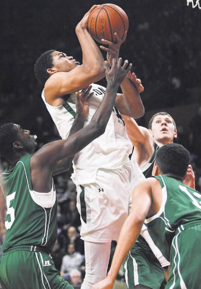 St. Joseph’s Karl Towns loses his hands on the ball while going to the hoop between East Brunswick defenders on Thursday, Feb. 27, 2014, in Piscataway.