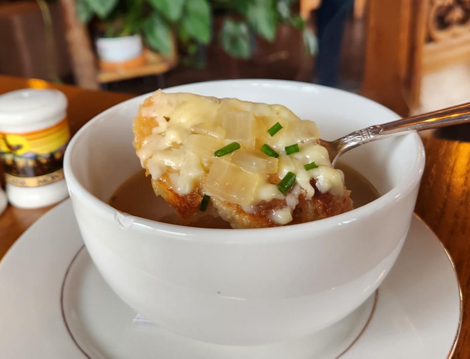 A bowl of onion soup is served topped with a cheesy Gruyere crouton at Say's on Friday, Dec. 8, 2023.