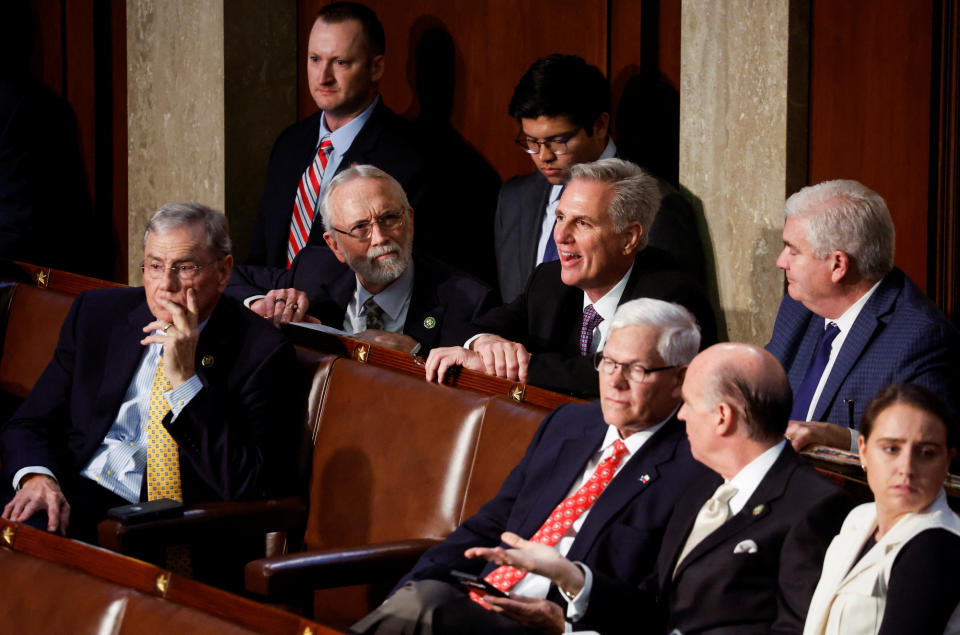 Republican Leader Kevin McCarthy smiles as he sits among members during another round of failed voting. 