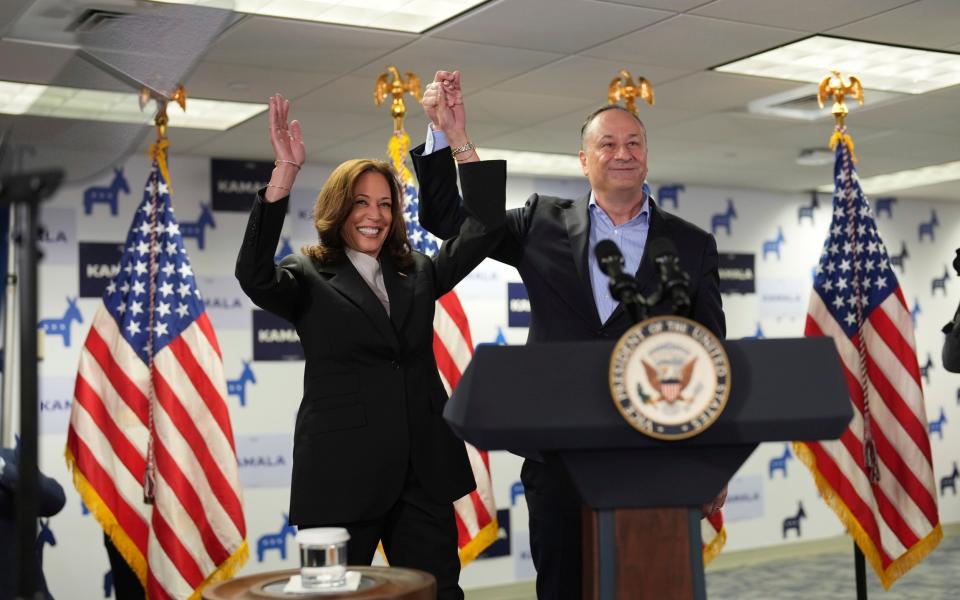 Kamala Harris, left, and second gentleman Doug Emhoff address staff at her campaign headquarters in Wilmington