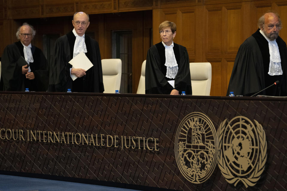 Presiding judge Joan Donoghue, second right, enters the World Court in The Hague, Netherlands, Thursday, July 13, 2023, where the United Nations' highest court delivers its judgment in a long-running maritime border dispute between Nicaragua and Colombia. (AP Photo/Peter Dejong)