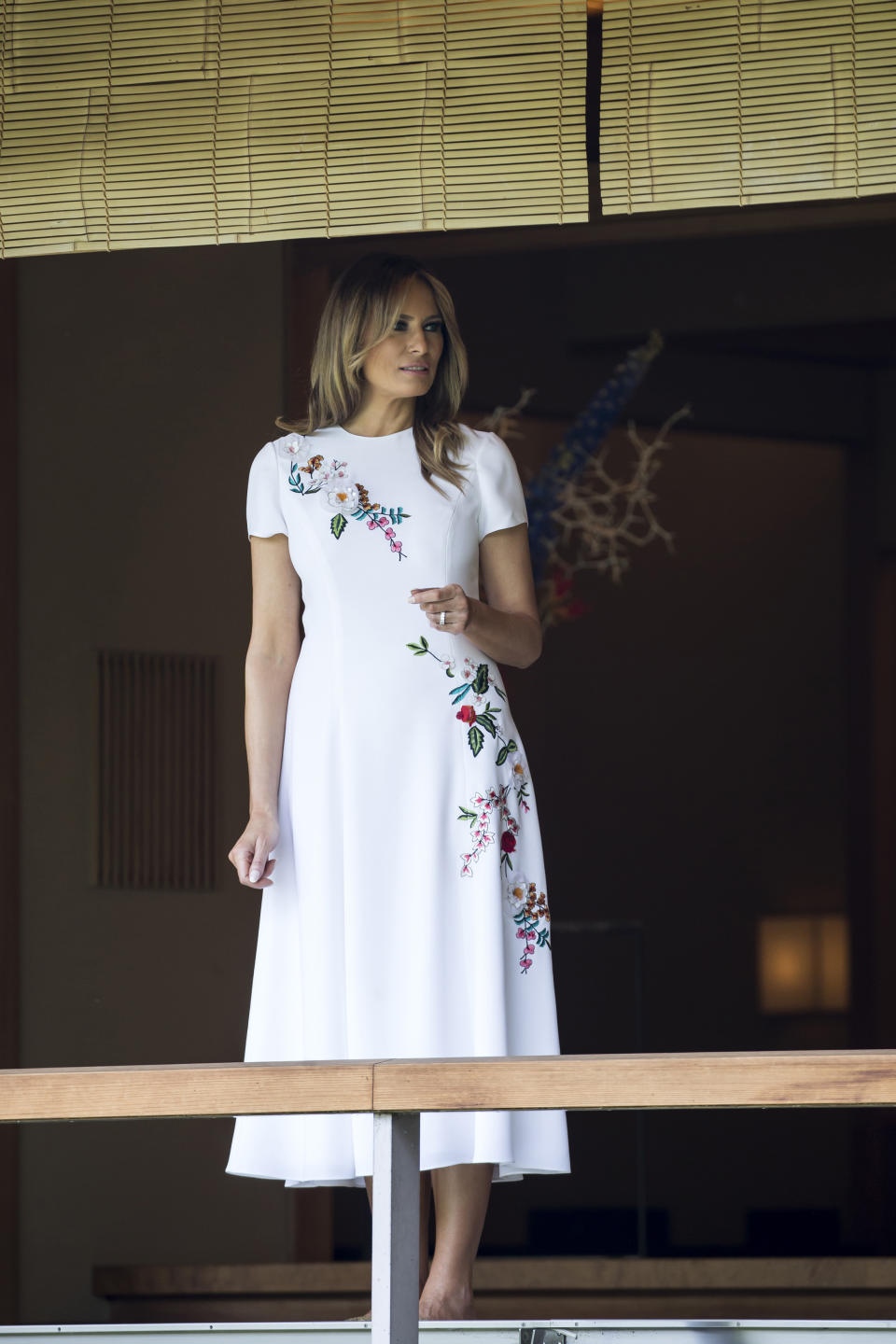 U.S. first lady Melania Trump looks at koi carps in a pond at the Japanese style annex inside the State Guest House in Tokyo Monday, May 27, 2019. (Tomohiro Ohsumi/Pool Photo via AP)