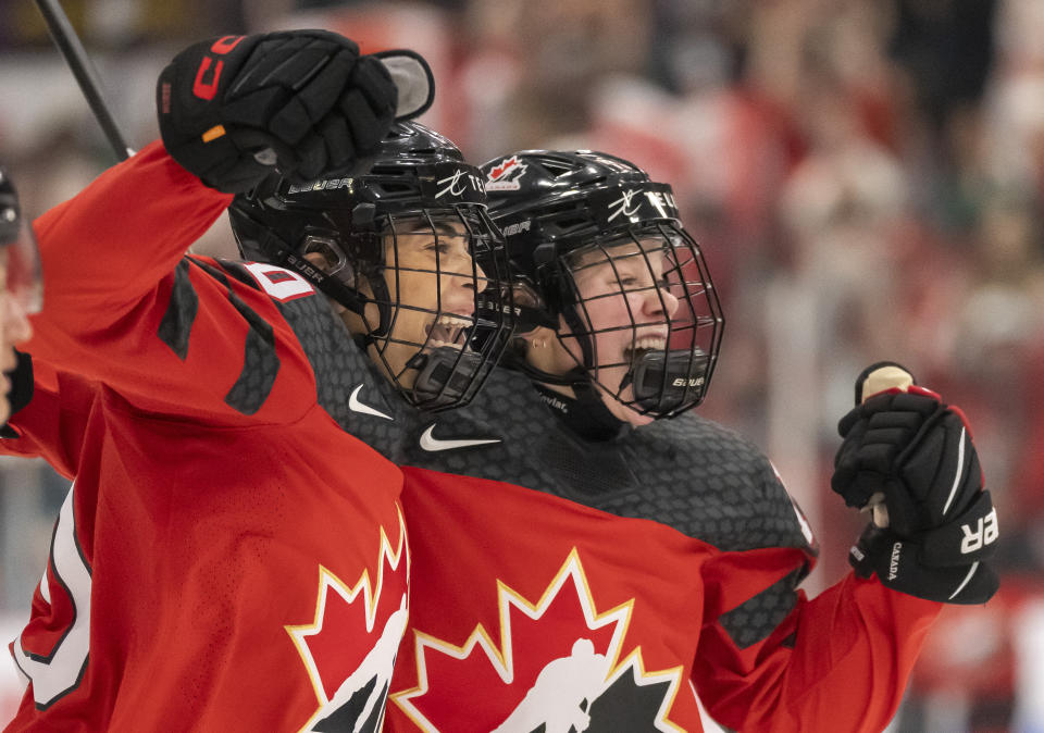 Canada forward Sarah Nurse, left, and forward Sarah Fillier, right, celebrate after Nurse's winning overtime goal against Sweden at a quarterfinal match at the women's world hockey championships in Brampton, Ontario, Thursday, April 13, 2023. (Frank Gunn/The Canadian Press via AP)