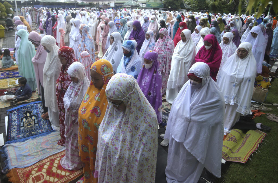 Muslim women perform Eid al-Adha prayers at a mosque in Denpasar, Bali, Indonesia, Sunday, July 10, 2022. Muslim people in the country celebrate Eid al-Adha, or the Festival of the Sacrifice, by slaughtering sheep, goats and cows whose meat later will be distributed to the poor. (AP Photo/Firdia Lisnawati)