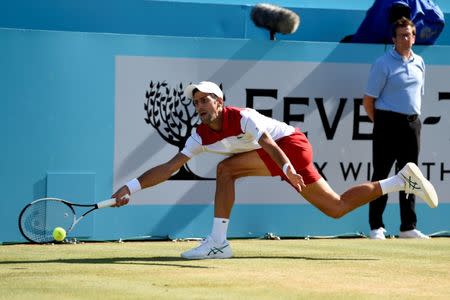 Tennis - ATP 500 - Fever-Tree Championships - The Queen's Club, London, Britain - June 24, 2018 Serbia's Novak Djokovic falls as he stretches for the ball during the final against Croatia's Marin Cilic Action Images via Reuters/Tony O'Brien