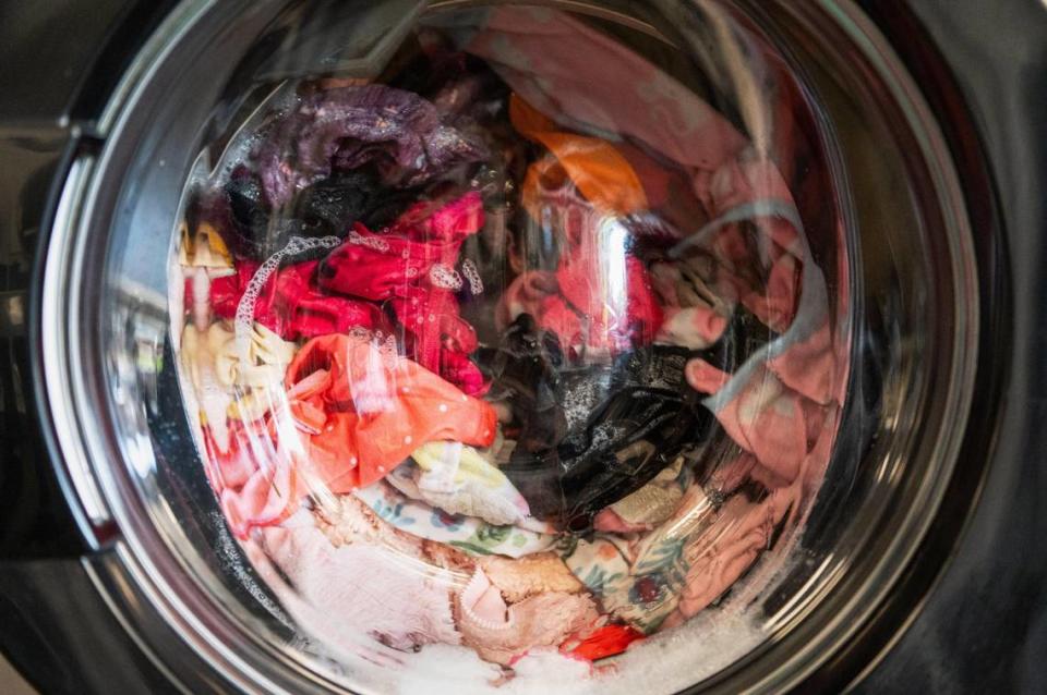 Clothing spins in a washing machine during Community Laundry Day on at Leah’s Laundromat on the Q. Free loads of laundry are funded through COPE, a Kansas City, Kansas, based non profit that spearheaded the free laundry day.