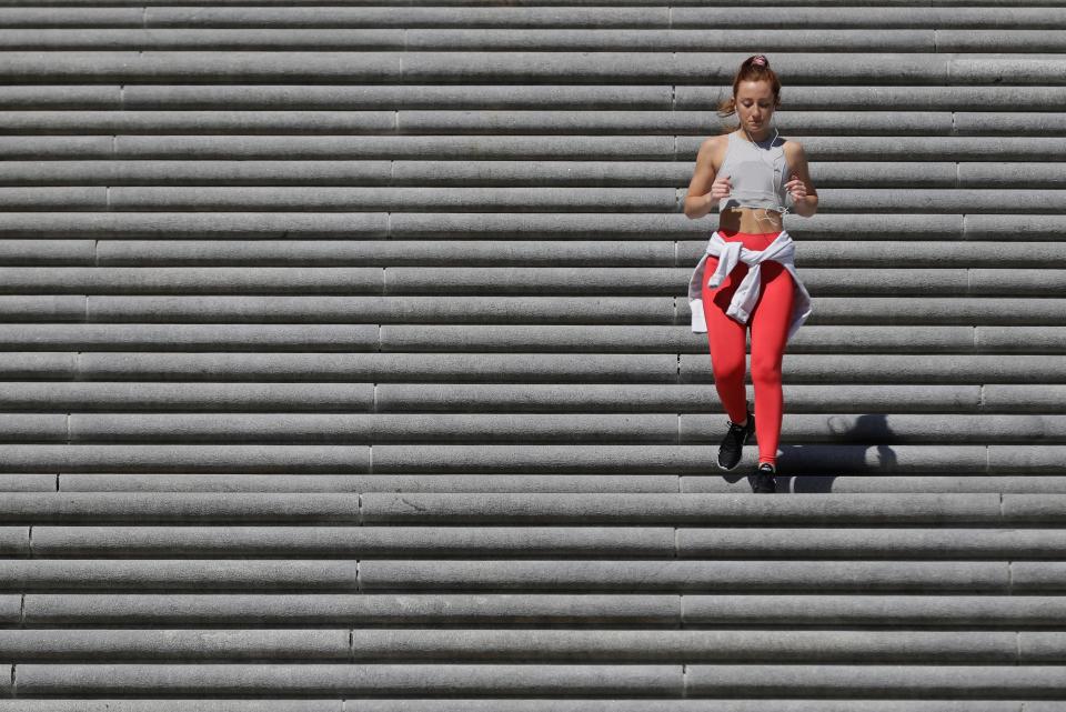 A runner races down the steps in front of the Indiana War Memorial on March 25 in Indianapolis.