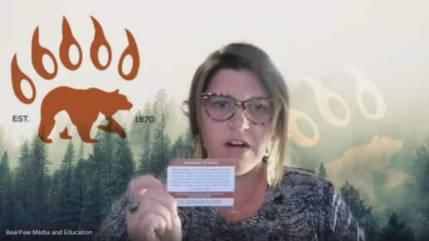 Daena Crosby, director of legal education, media and research with Native Counselling Services of Alberta, holds up the printed card with the statement to police that can be read.