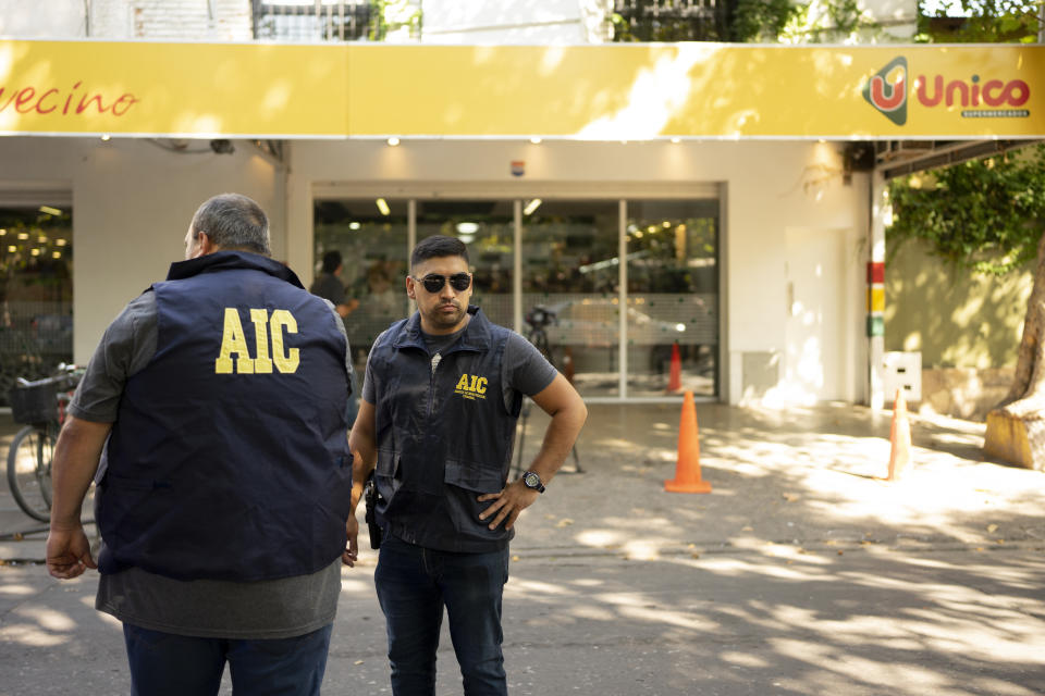 Police gather at the Unico supermarket, a grocery chain owned by soccer player Lionel Messi's in-laws, after it was shot at in Rosario, Argentina, Thursday, March 2, 2023. (AP Photo/Sebastian Lopez Brach)