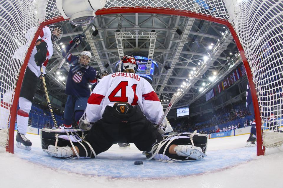 Hilary Knight of the Untied States celebrates as the puck slides past Goalkeeper Florence Schelling of Switzerland for a goal during the first period of the women's ice hockey game at the 2014 Winter Olympics, Monday, Feb. 10, 2014, in Sochi, Russia. (AP Photo/Bruce Bennett, Pool)