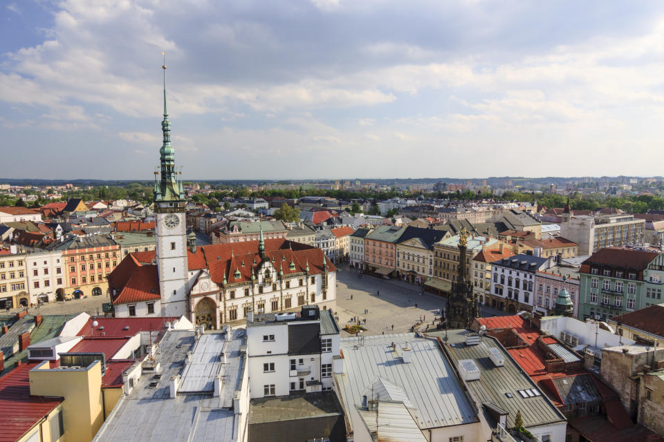 Aerial view of Olomouc, showing a grand plaza with various charming architecture on show.