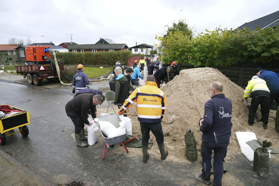 Residents and members of the the Emergency Management Agency prepare for the heavy wind and increased water levels, at Kelstrup Strand, in Haderslev, southern, Denmark Thursday, Oct. 19, 2023. Southern Scandinavia and northern Germany braced for bad weather with gale force winds over the next days. Authorities said Thursday that floods could cause major problems in inner Danish waters and in the Baltic Sea. (Claus Fisker/Ritzau Scanpix via AP)