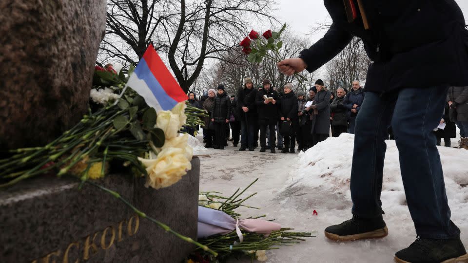 People gather at the Solovetsky Stone monument in St Petersburg on Saturday. - Stringer/Reuters