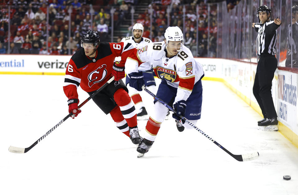 Florida Panthers left wing Matthew Tkachuk (19) plays the puck against New Jersey Devils defenseman John Marino (6) during the first period of an NHL hockey game, Tuesday, March 5, 2024, in Newark, N.J. (AP Photo/Noah K. Murray)