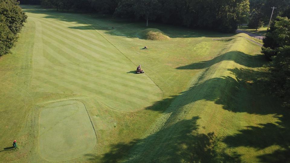 A groundskeeper mows near the flat-topped mound that is part of the 50-acre octagon. The Octagon Earthworks in Newark are hoping to become a UNESCO World Heritage Site. Moundbuilder's Country Club, an 18-hole golf course, has been leasing the property from the Ohio History Connection.