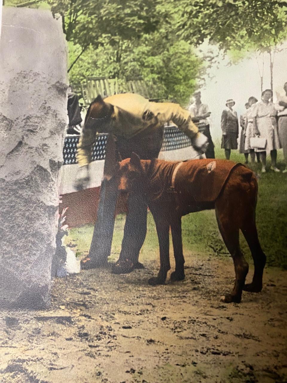 A photo of U.S. Marine Sgt. Sparks, a Doberman pinscher, in 1946, at the dedication ceremony of a war dog monument at what is now the Michigan War Dog Memorial. Sparks served two-and-a-half years overseas in World War II. He is recognized for many heroic acts of saving lives by alerting soldiers to potential ambushes. He is buried at Michigan War Dog Memorial in Lyon Township.