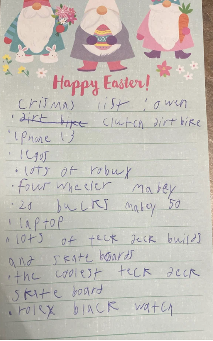 Handwritten Christmas list on a "Happy Easter!" piece of paper, including a clutch dirt bike, iPhone 13, Legos, skateboard, and laptop