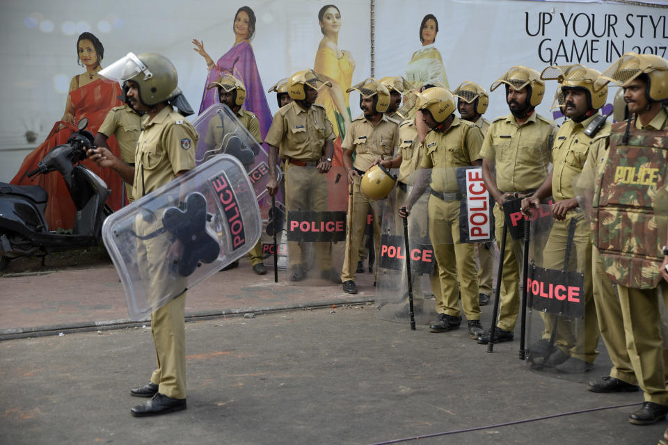 Policemen stand guard near the state secretariat anticipating protests following reports of two women of menstruating age entering the Sabarimala temple, one of the world's largest Hindu pilgrimage sites, in Thiruvananthapuram, Kerala, India, Wednesday, Jan. 2, 2019. Two women on Wednesday entered one of India's largest Hindu pilgrimage sites that had been forbidden to females between the ages of 10 and 50, sparking protests across a southern state, with police firing tear gas at several places to break up stone-throwing protesters, police said. (AP Photo/R S Iyer)