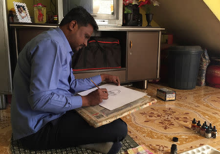 Ganesh Bhalerao, a cartoonist hired by the ruling Bharatiya Janata Party, draws a cartoon inside his home in Pune, India, February 28, 2019. Picture taken February 28, 2019. REUTERS/Rajendra Jadhav