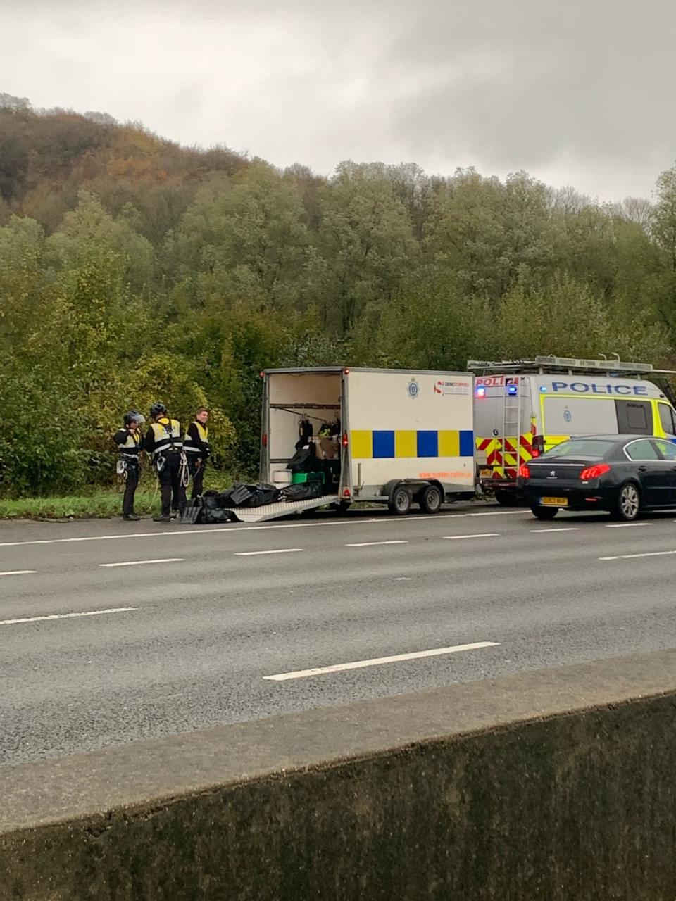 Surrey Police responded to protesters on overhead gantries along the M25 (PA)