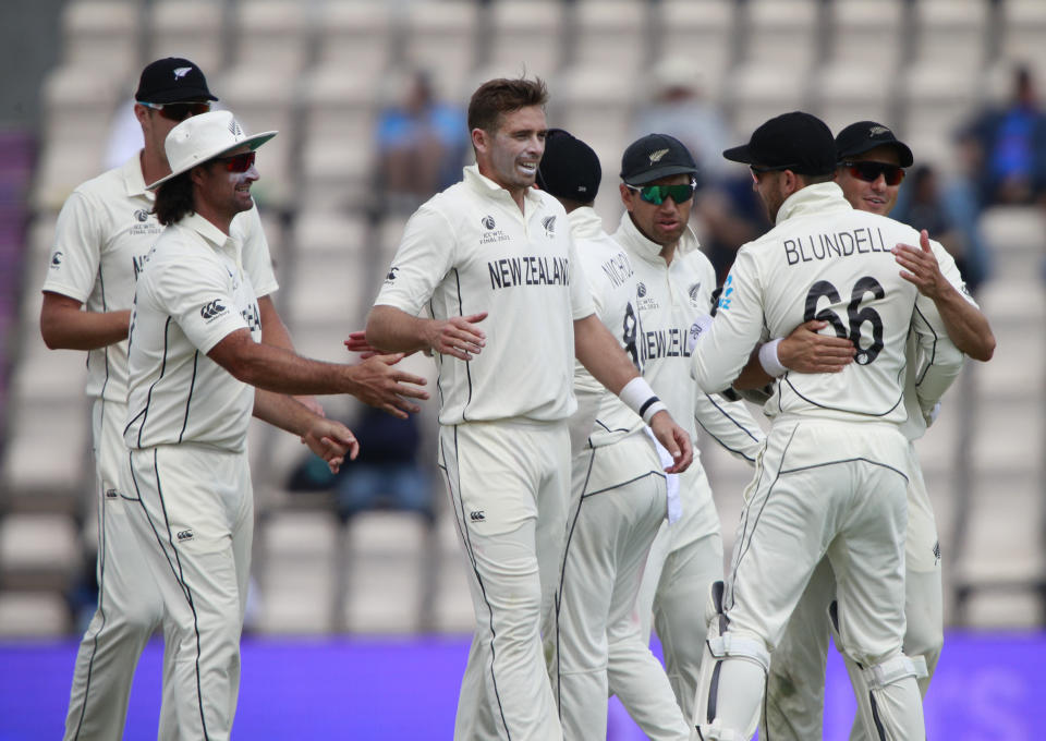 New Zealand's Tim Southee, center without cap, celebrates with teammates the dismissal of India's Jasprit Bumrah during the sixth day of the World Test Championship final cricket match between New Zealand and India, at the Rose Bowl in Southampton, England, Wednesday, June 23, 2021. (AP Photo/Ian Walton)