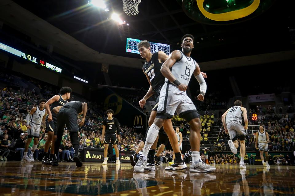 Oregon forward Quincy Guerrier celebrates a dunk as the Oregon Ducks host the Colorado Buffaloes at Matthew Knight Arena in Eugene, Ore. Thursday, Jan. 26, 2023. 