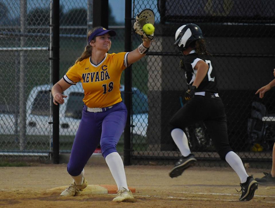 Nevada first baseman Samantha Herridge (18) catches the ball for a force out of Grand View Christian's Livy VanDerSluis during the fifth inning at Nevada Softball Field Friday, June 24, 2022, in Nevada, Iowa.