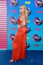 <p>The <i>Diary of a Wimpy Kid</i> actor styled her blond locks loose, showing a bare back in a bright red silk jumpsuit. (Photo: Getty Images) </p>