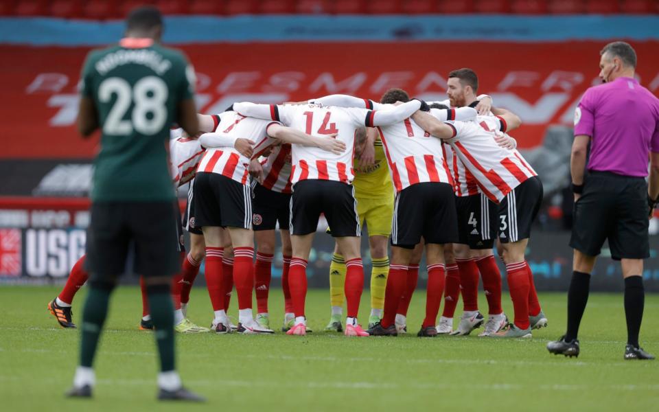 Sheffield United huddle before their clash against Tottenham on Sunday - Tom Jenkins