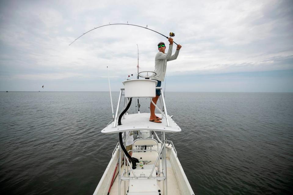 Johnny Fairbanks, a Hatteras native and a recent high school graduate casts for drum from his boat in the Pamlico Sound on Wednesday, July 21, 2021 in Hatteras, N.C. Fairbanks has started his own charter fishing business.