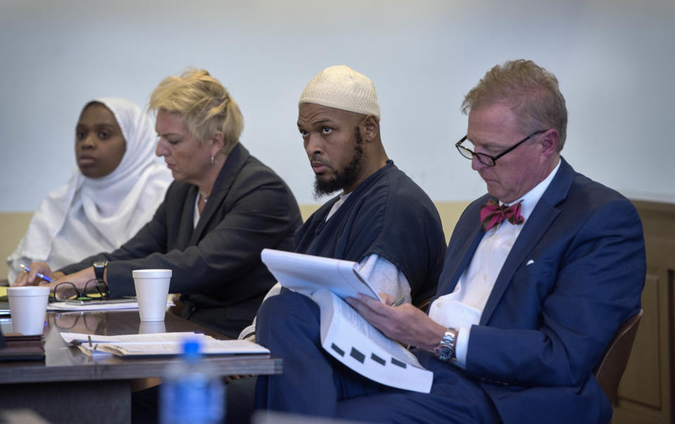 Jany Leveille, from left, with her attorney Kelly Golightley, and Siraj Ibn Wahhaj with attorney Tom Clark listen to the prosecutor during a hearing on a motion to dismiss in the Taos County Courthouse, Wednesday, Aug. 29, 2018. Judge Jeff McElroy ordered lesser charges of neglect against both defendants dropped as the result of a deadline missed by prosecutors. (Eddie Moore/The Albuquerque Journal via AP, Pool)