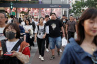 People walk in Wangfujing shopping street in Beijing, China May 15, 2019. REUTERS/Thomas Peter