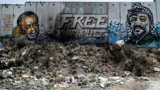 Jailed Palestinian figure Marwan Barghuti (L) from Abbas's Fatah movement has become an icon of Palestinian resistance, seen here alongside late leader Yasser Arafat on Israel's controversial separation wall