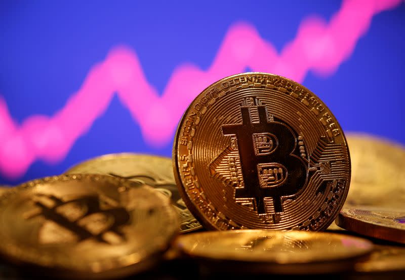 FILE PHOTO: A representation of virtual currency Bitcoin is seen in front of a stock graph in this illustration taken