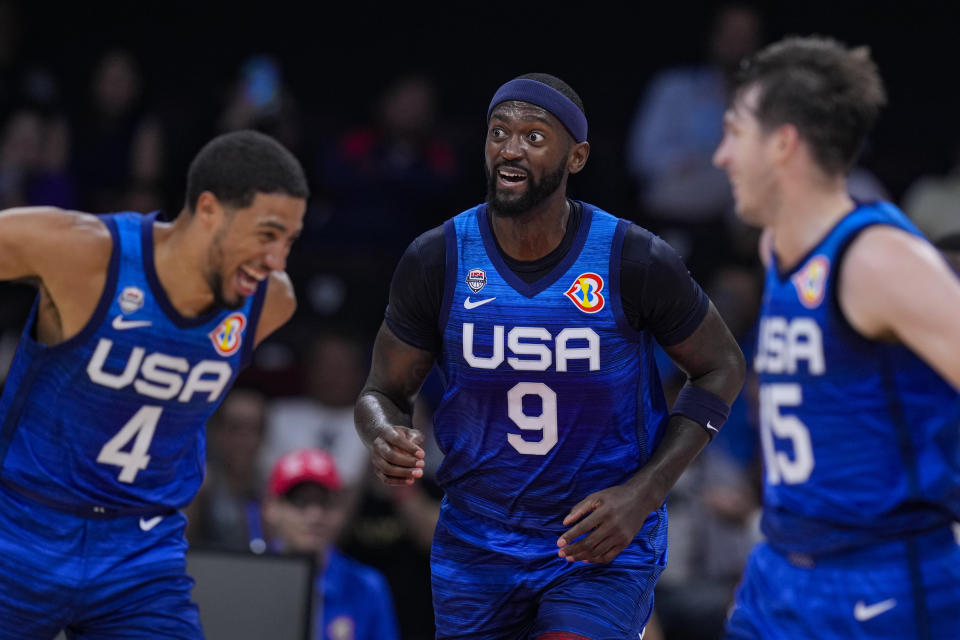 U.S. forward Bobby Portis Jr. (9) celebrates between teammates Tyrese Haliburton (4) and Austin Reaves (15) during the second half of a Basketball World Cup group C match against Greece in Manila, Philippines Monday, Aug. 28, 2023.(AP Photo/Michael Conroy)