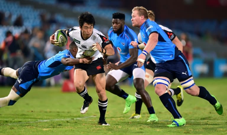 Warrick Gelant (L) of the Blue Bulls tackles Takaaki Nakazuru (C) of the Sunwolves during their Super XV rugby union match on March 17, 2017 in Pretoria, South Africa