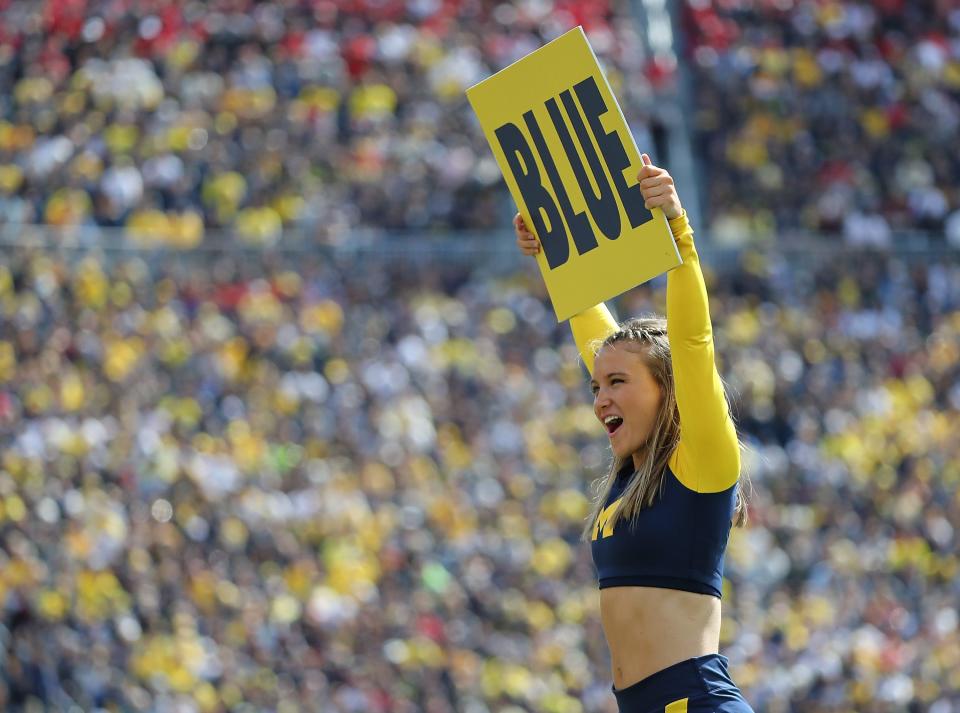 A Michigan cheerleader displays a sign in the fourth quarter of the Wolverines' 36-14 victory over Cincinnati at Michigan Stadium on September 9, 2017.