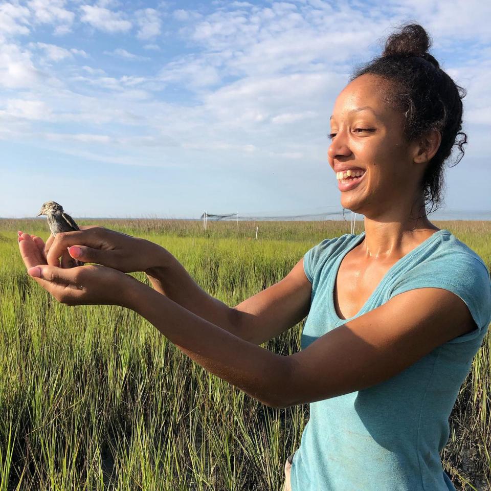 Corina Newsome with a seaside sparrow, the subject of her graduate studies at Georgia Southern University.