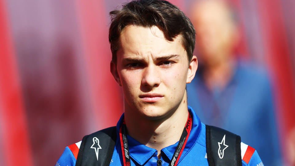 Oscar Piastri is pictured walking through the F1 paddock.