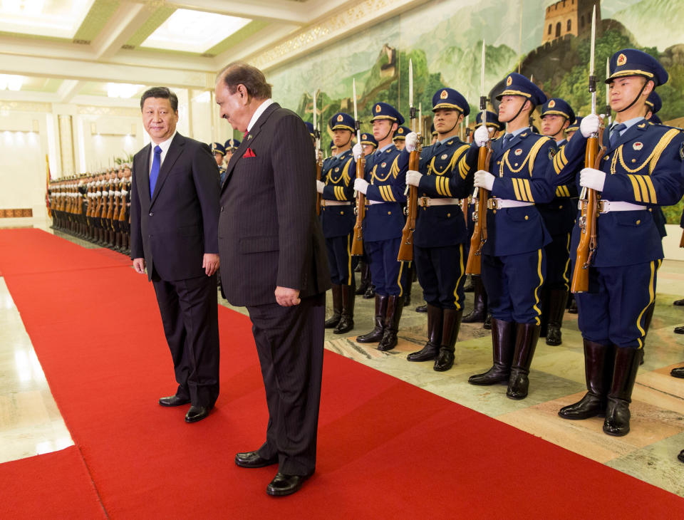 Pakistan's President Mamnoon Hussain, right, attends a welcoming ceremony with Chinese President Xi Jinping at the Great Hall of the People in Beijing, China, Wednesday, Feb. 19, 2014. Pakistani President Hussain is scheduled to meet Chinese leaders on a visit to Beijing focused on winning assistance for his country's ailing economy. (AP Photo/Adrian Bradshaw, Pool)