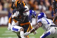 Tennessee defensive back Brandon Turnage (8) , front left, is hit by a Kentucky defender after making an interception during the second half of an NCAA college football game Saturday, Oct. 29, 2022, in Knoxville, Tenn. (AP Photo/Wade Payne)