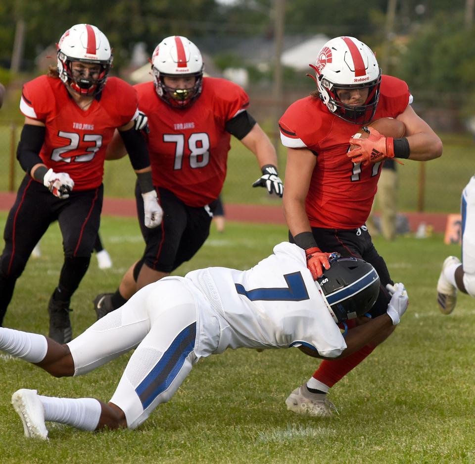 Tristin Panza runs over Sean Williams of Ypsilanti Lincoln. Panza, who played receiver and safety for Monroe High, will line up at quarterback in the Monroe County High School All-Star Football Game at Airport Friday night.