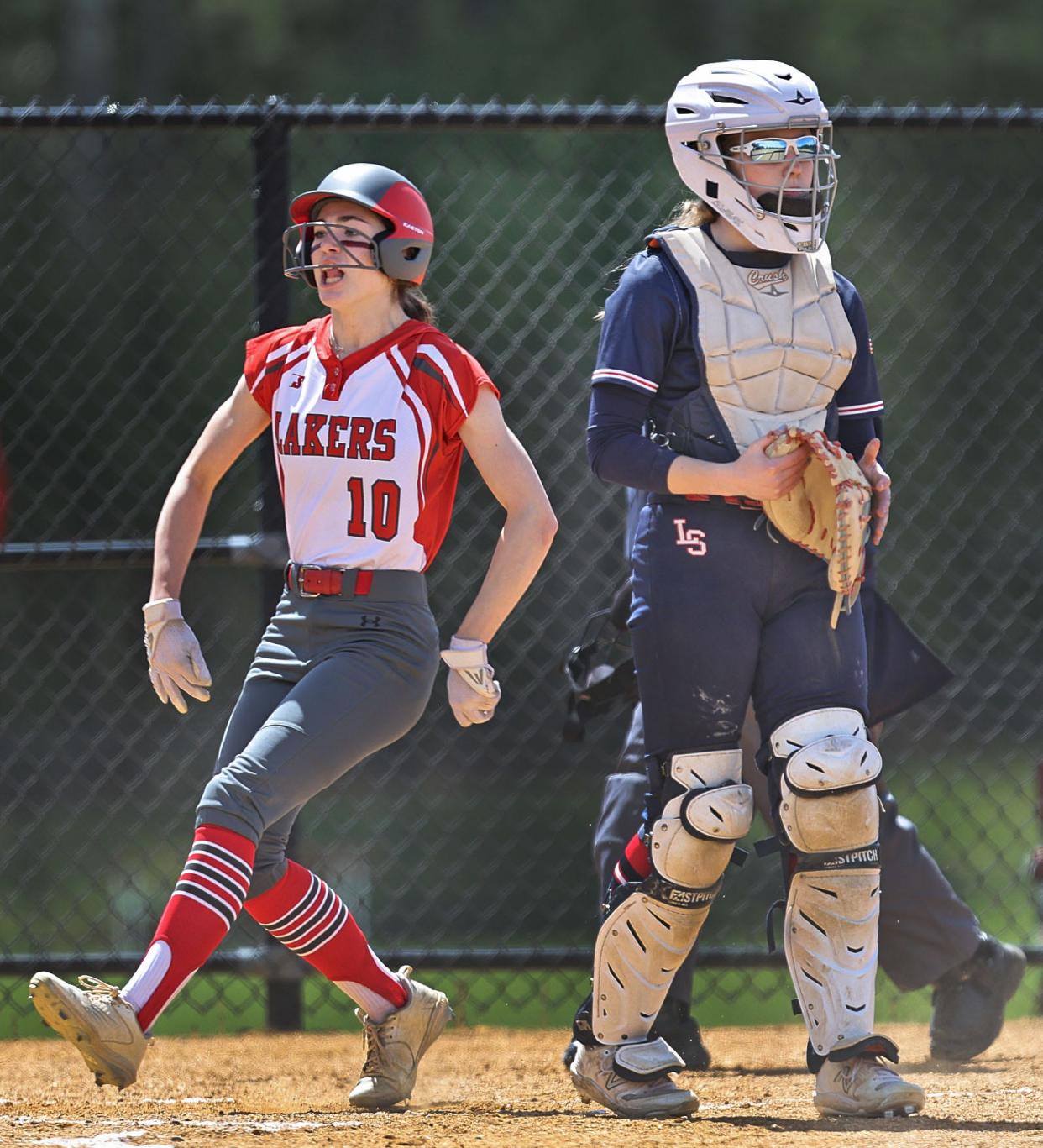 Silver Lake shortstop Samantha Waters crosses the plate behind Lincoln-Sudbury catcher Ashleigh Lent to score on an error in the third inning, tying the game at 1-1. Lincoln-Sudbury prevailed, 2-1, in 8 innings on Wednesday, April 17, 2024.