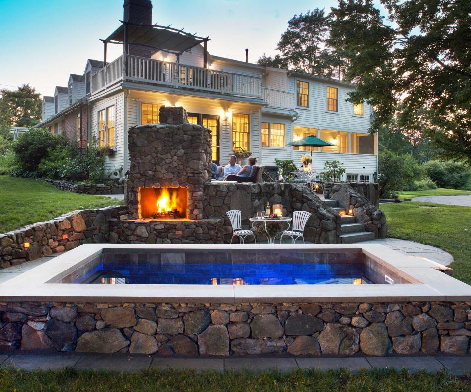 pool with outdoor fireplace