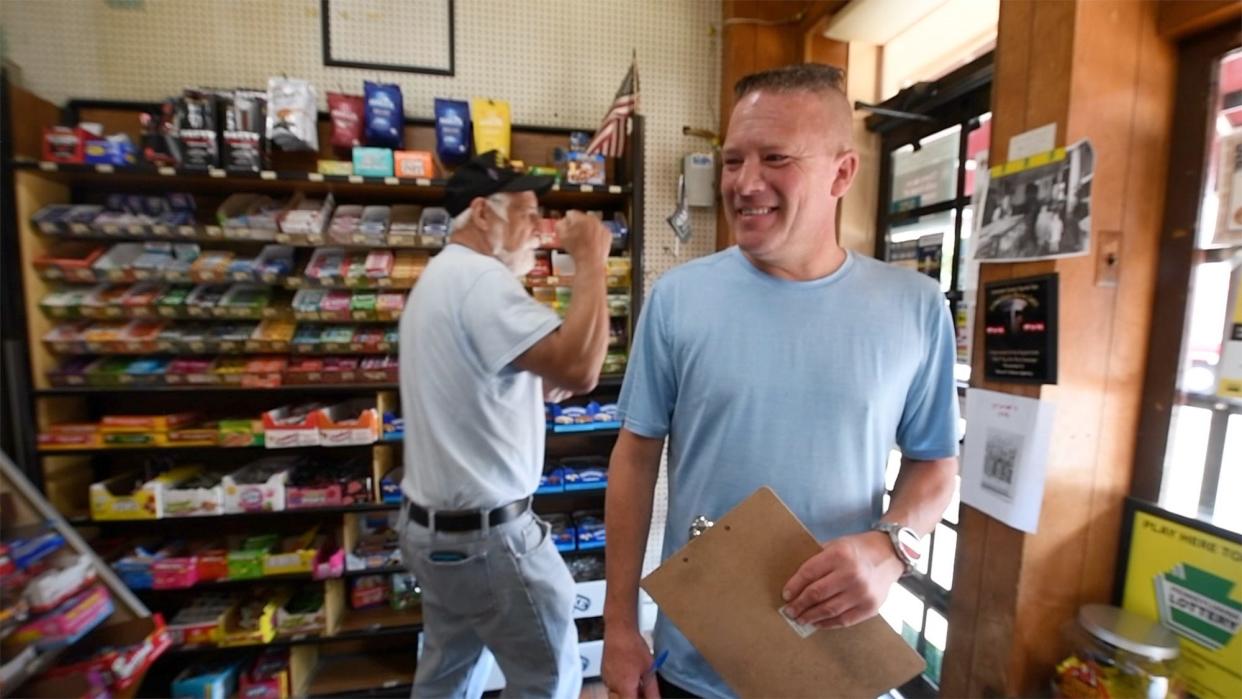 James Stover, representing the fifth generation to own Stover’s News, in Columbia, looks back as a customer pumps his hand and saying 'Trumpy' multiple times on Aug. 26, 2024. Stover said the two biggest issues in Columbia are homelessness and the economy.