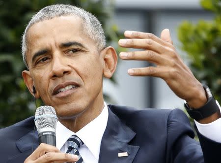 Former U.S. President Barack Obama speaks during a discussion at the German Protestant Kirchentag in front of the Brandenburg Gate in Berlin, Germany, May 25, 2017. REUTERS/Fabrizio Bensch