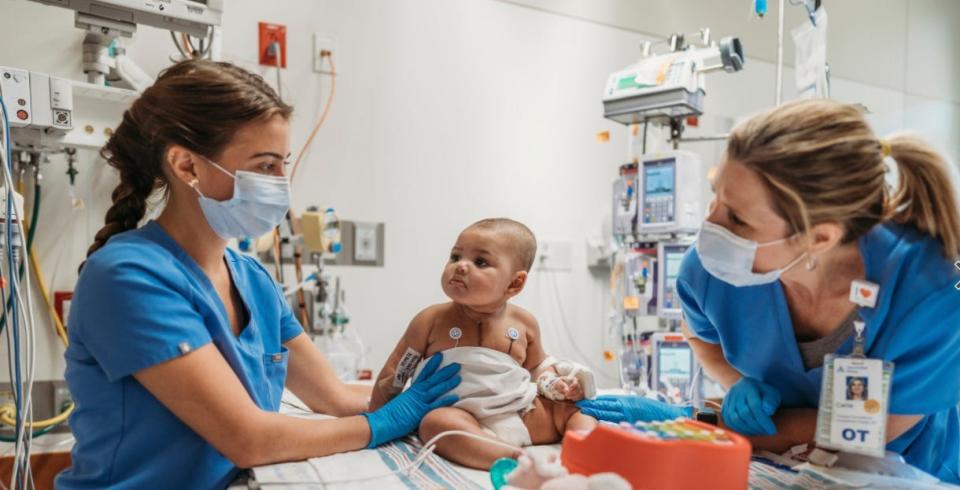 Dell Children's Medical Center's team checks Zaria Grace Jackson as she prepares to go home in April 2021. The 6-month-old Austin infant had a Berlin Heart ventricular assist device for 73 days before her heart transplant.