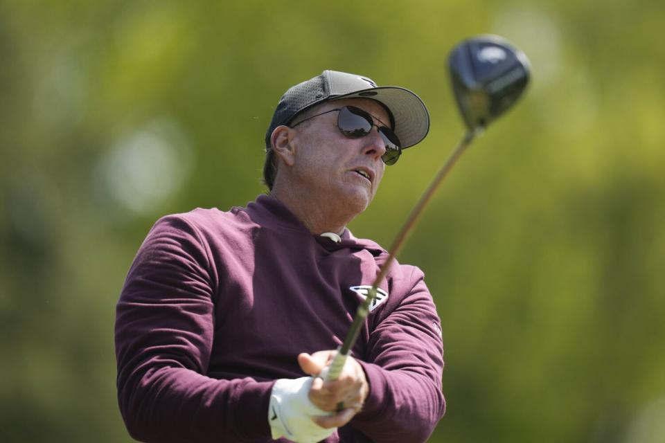 Phil Mickelson watches his tee shot on the fourth hole during a practice round for the PGA Championship.