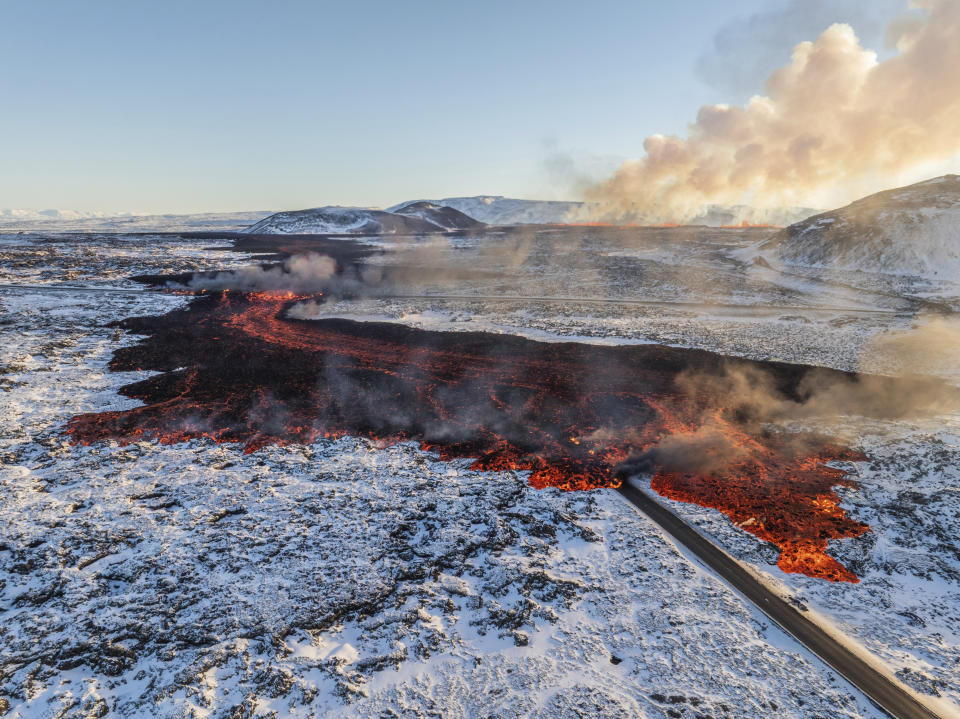 A view of lava crossing the main road to Grindavík and flowing on the road leading to the Blue Lagoon, in Grindavík, Iceland, Thursday, Feb. 8, 2024. A volcano in southwestern Iceland has erupted for the third time since December and sent jets of lava into the sky. The eruption on Thursday morning triggered the evacuation the Blue Lagoon spa which is one of the island nation’s biggest tourist attractions. (AP Photo /Marco Di Marco)