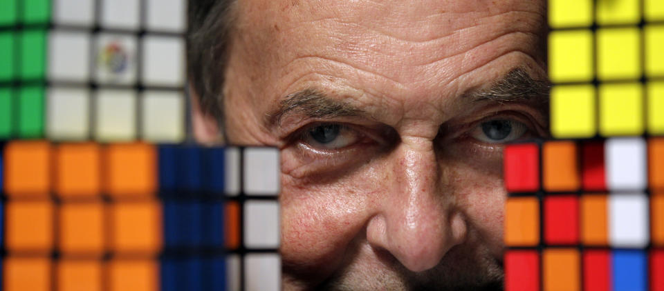 Erno Rubik, the inventor of the Rubik's Cube, poses for The Associated Press with cubes at Liberty Science Center, Wednesday, April 25, 2012, in Jersey City, N.J. The center will have an exhibit on the toys and will include a cube made with diamonds that is worth 2.5 million dollars. (AP Photo/Julio Cortez)